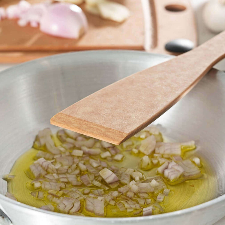 Kitchen Series Angled Turner in Natural sautéing onions in oil 